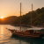 Traditional Turkish gulet anchored in a tranquil cove near Bodrum at sunset with guests dining on deck