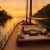 Traditional wooden gulet anchored in a secluded turquoise cove near Fethiye at sunset with guests relaxing on deck